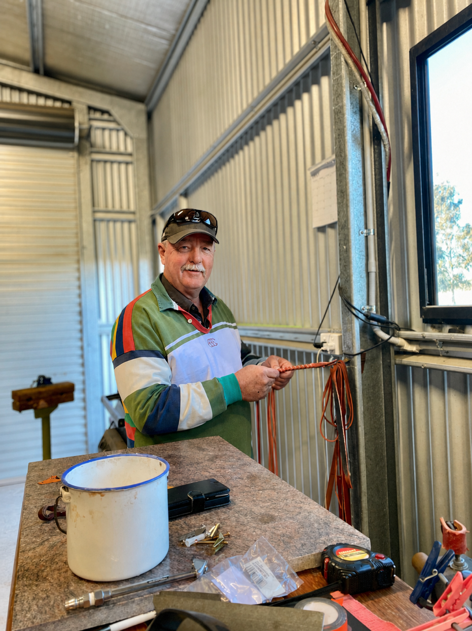 Man working on a metal object in a workshop